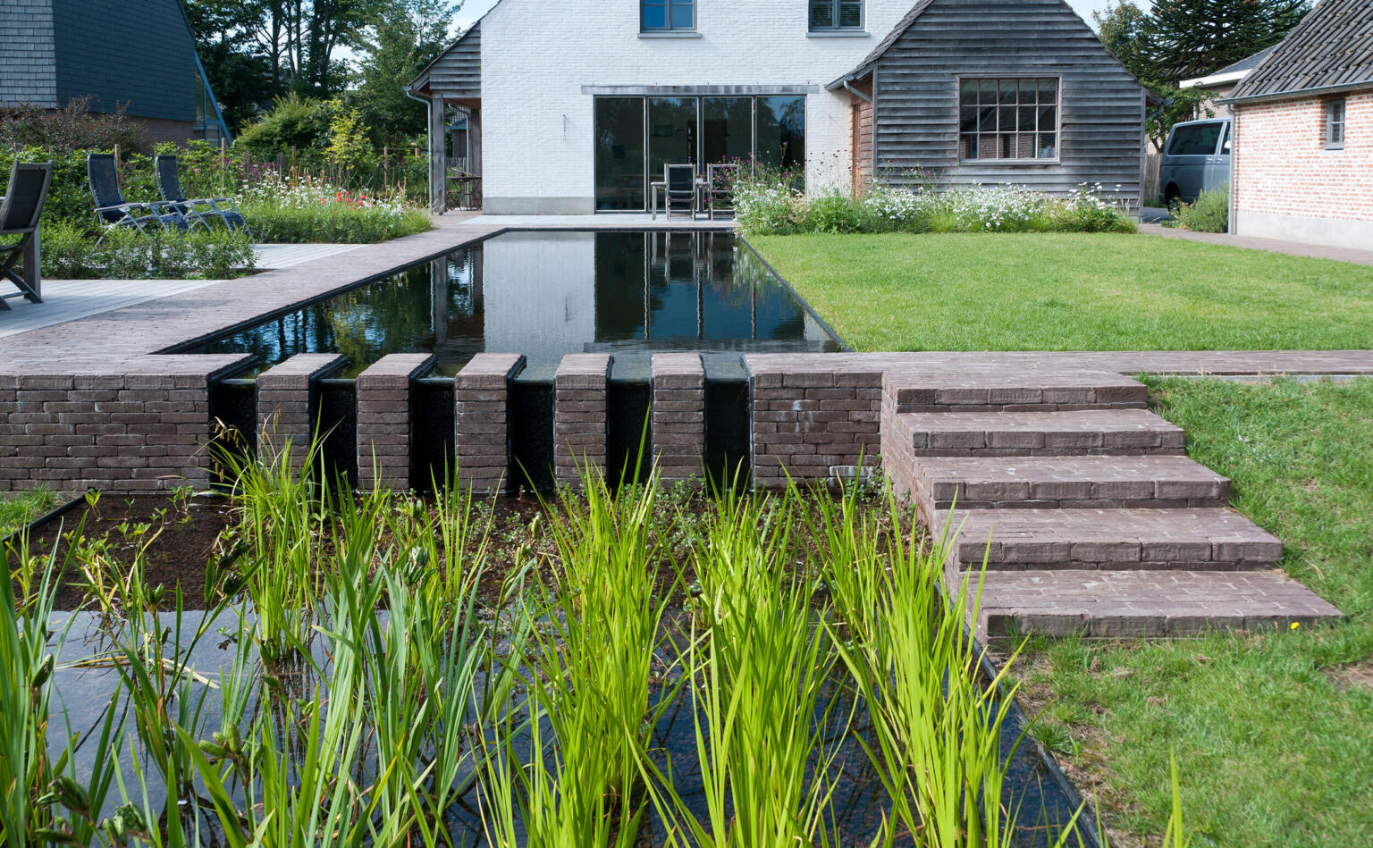 Greenarchitects stefaan willems tuinarchitect laarne Zwemvijver met keermuur en trappen